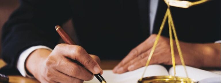 Attorney signing documents, embodying the diligent work at Kevin R. Hansen's Las Vegas personal injury law practice