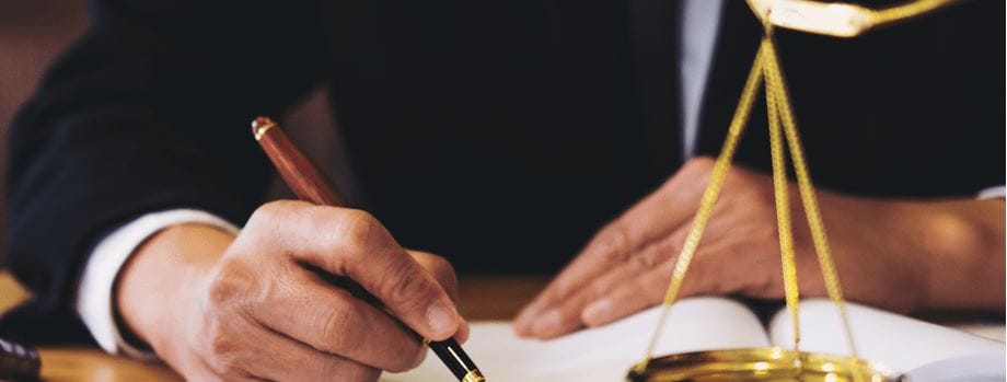 Attorney signing documents, embodying the diligent work at Kevin R. Hansen's Las Vegas personal injury law practice