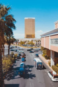 Bus on a bustling Las Vegas roadway with casino backdrop, representing bus accident cases handled by Kevin R. Hansen Law Office