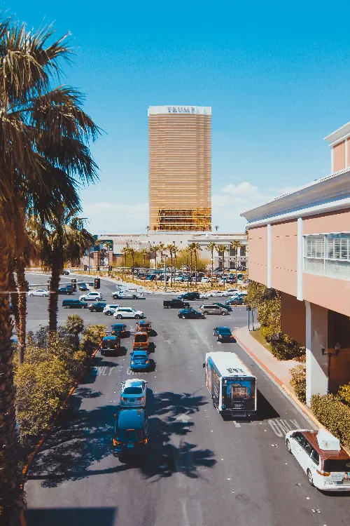 Bus on a bustling Las Vegas roadway with casino backdrop, representing bus accident cases handled by Kevin R. Hansen Law Office